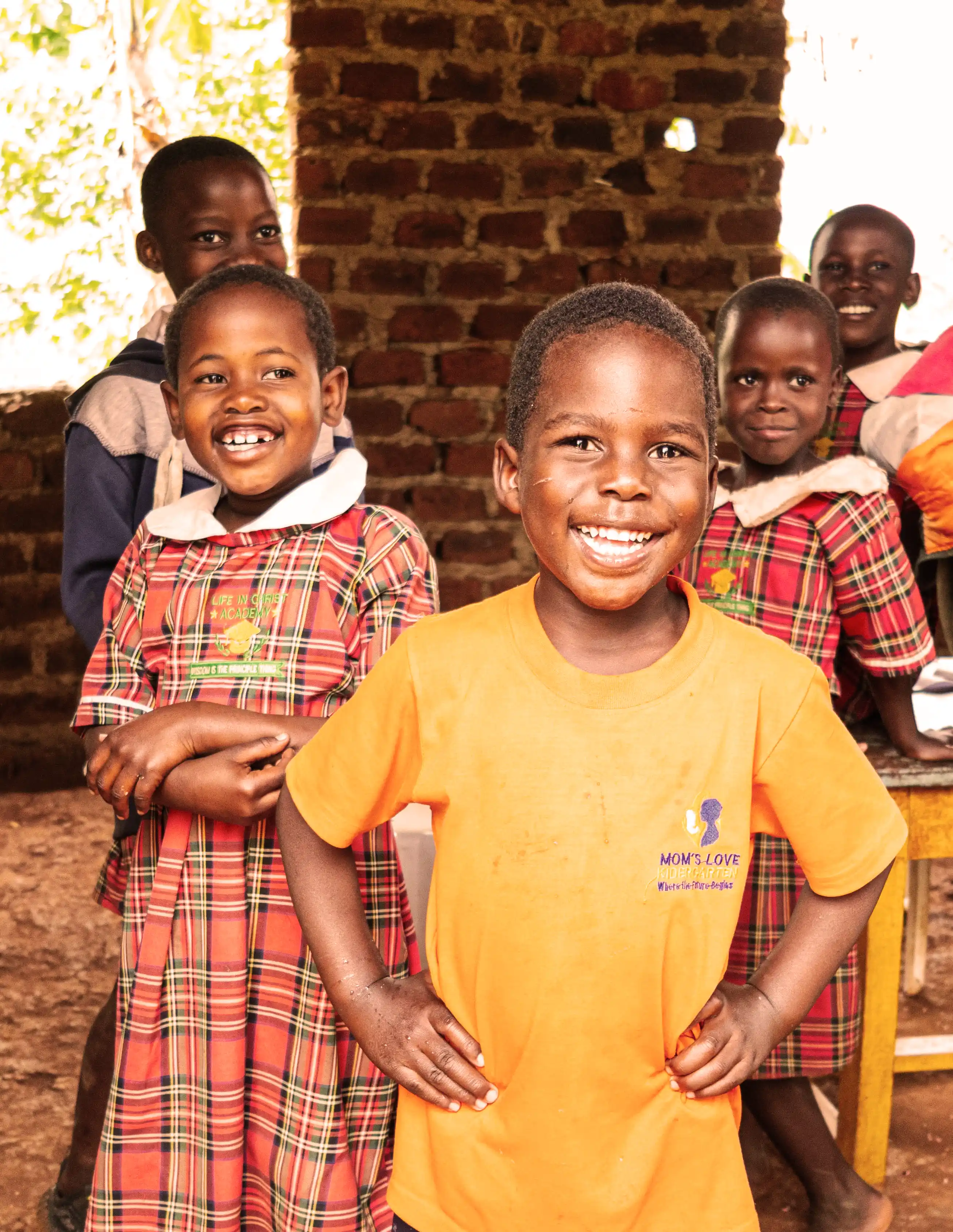 Smiling children in yellow school uniforms in Uganda